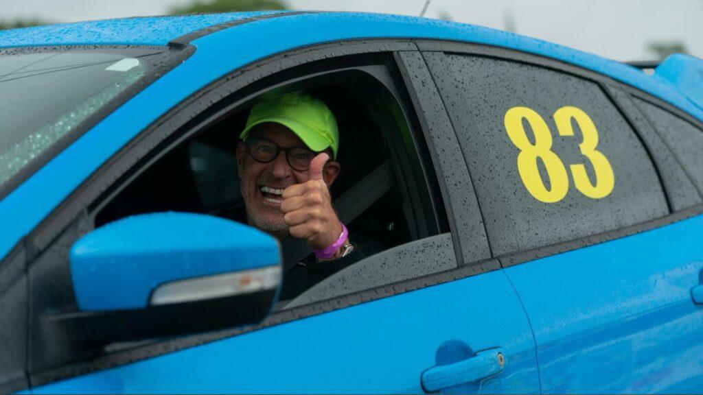 Steve Fureman giving a thumbs up from his track car